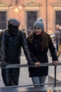 Young woman enjoying the winter in Madrid Spain taking photo beside the statue the curious neighbor Royalty Free Stock Photo