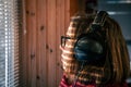 A woman with headphones looks through the blinds at the early morning sunlight. Royalty Free Stock Photo