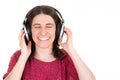 Young woman enjoys musicians music in headphones on white background