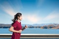 Young woman enjoys running outside with beautiful summer in the lake Royalty Free Stock Photo