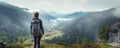 A young woman enjoys the view of the summer mountains while on a mountain peak.