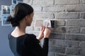 Young woman entering security pin on home alarm keypad Royalty Free Stock Photo