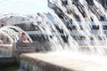 The young woman escaping heat wave in city fountain