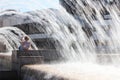 The young woman escaping heat wave in city fountain