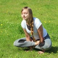 Young woman of European appearance does yoga in summer nature Royalty Free Stock Photo