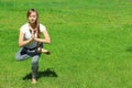 Young woman of European appearance does yoga in summer nature Royalty Free Stock Photo