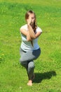 Young woman of European appearance does yoga in summer nature Royalty Free Stock Photo