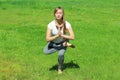 Young woman of European appearance does yoga in summer nature Royalty Free Stock Photo