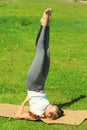 Young woman of European appearance does yoga in summer nature Royalty Free Stock Photo