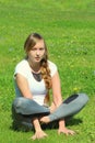 Young woman of European appearance does yoga in summer nature Royalty Free Stock Photo