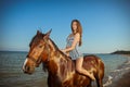 Young woman evening beach horse ride Royalty Free Stock Photo