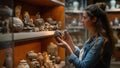 Young woman examining ancient pottery in museum