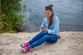 Young smiling woman in excellent spirits with a phone and listens to music Royalty Free Stock Photo