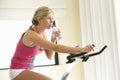 Young Woman On Exercise Bike Royalty Free Stock Photo