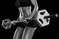 Young woman exercises with barbell isolated over black background Royalty Free Stock Photo