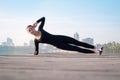 Young woman exercises on pier during sport training workout