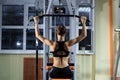 Young Woman Exercising Back On Machine In The Gym And Flexing Muscles - Muscular Athletic Bodybuilder Fitness Model Royalty Free Stock Photo