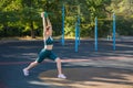Young woman exercising with a ball on a street sports ground Royalty Free Stock Photo