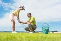 Young woman exercising the golf swing helped by her instructor Royalty Free Stock Photo