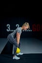 Young woman exercising with kettlebells at the gym. Squats squatting swing WOD fitness gym. Fitness woman workout with Royalty Free Stock Photo