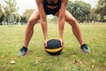 Young woman exercising with medicine ball in park Royalty Free Stock Photo