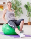 Young woman exercising with stability ball in gym Royalty Free Stock Photo