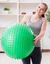 Young woman exercising with stability ball in gym Royalty Free Stock Photo