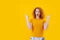 Young woman exhilarated by discovery over yellow background