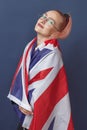 Young woman expat in eyeglasses with great britain flag. Studio shot. English language hipster teacher