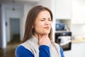 Young woman experiencing throat ache