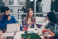 Young woman explaining diagrama of financial growh on meeting sitting at desktop