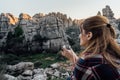 Young woman explorer drinking coffee while looking at the mountain.