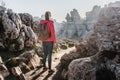 Young woman explorer with her backpack hiking in the mountains.