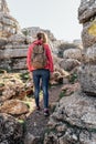 Young woman explorer with her backpack hiking in the mountains.