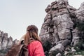 Young woman explorer with her backpack looking at the mountain.