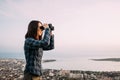 Traveler woman looking through binoculars outdoor. Royalty Free Stock Photo