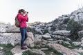 Young woman explorer photographing in the mountain.