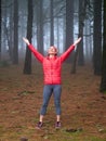 Young woman exploring stunning autumn foggy forest