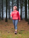 Young woman exploring stunning autumn foggy forest