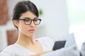 Young woman with eyeglasses on smartphone