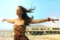 Young woman eyes closed arms wide open at beach Royalty Free Stock Photo