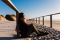 Young woman with eyes closed relaxing at beach at sunset. Holidays and relaxation concept Royalty Free Stock Photo