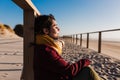 Young woman with eyes closed relaxing at beach at sunset. Holidays and relaxation concept Royalty Free Stock Photo