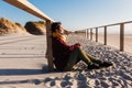 Young woman with eyes closed relaxing at beach at sunset. Holidays and relaxation concept Royalty Free Stock Photo