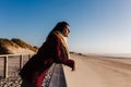 Young woman with eyes closed relaxing at beach at sunset. Holidays and relaxation concept Royalty Free Stock Photo