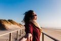 Young woman with eyes closed relaxing at beach at sunset. Holidays and relaxation concept Royalty Free Stock Photo