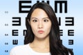 woman with eyesight test chart background Royalty Free Stock Photo