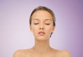 Young woman face with bare shoulders over violet Royalty Free Stock Photo