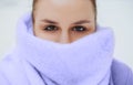 Young woman face covered with light colored knitted scarf Royalty Free Stock Photo