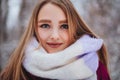 Young woman face covered with light colored knitted scarf Royalty Free Stock Photo